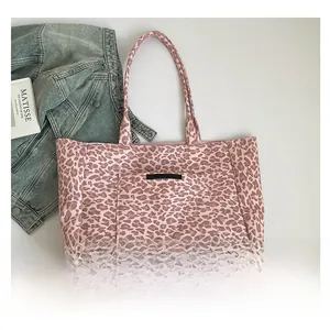 Détail du sac cabas rose à imprimé léopard avec poche avant et longues bandoulières