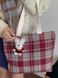 Vintage red and blue plaid woven tote bag with a white plush bunny charm on shoulder strap