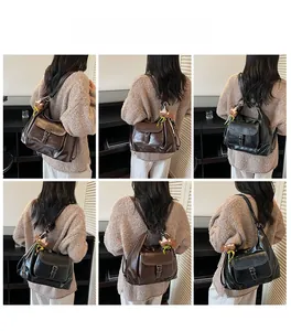 Rear view of vintage faux leather backpack in brown and black with bear pendant