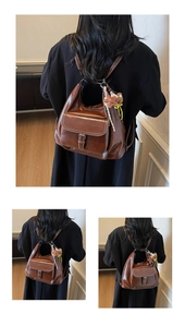 Detail view of brown vintage leather backpack with front flap pocket and metal ring attachment