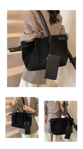 Detail view of black matte suede tote bag set with adjustable straps and small pouch