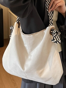 White canvas tote bag with contrast woven rope handles and large capacity design
