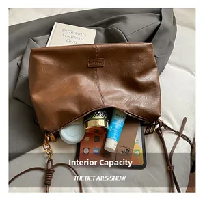 Top view of the deep brown leather bag showing spacious interior with daily essentials