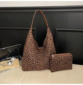 Detail of leopard print tote bag with small matching pouch and brown leather straps