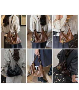 Detail shots of versatile large hobo bag in black and brown with leopard charm