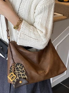 Brown vintage leather hobo tote bag for women featuring a stylish gold letter B charm