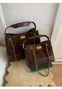 Close-up of retro brown bucket bags with diamond quilting and gold chain strap detail