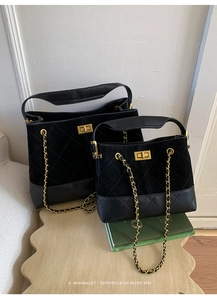 Detail view of retro black quilted handbags in two sizes with gold chain and turn-lock