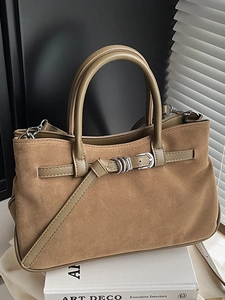 Brown suede baguette bag with buckle strap and dual top handles in minimalist style