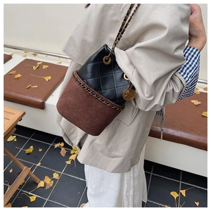 Quilted black leather and brown suede bucket bag with chain strap and vintage charm