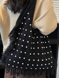 Handmade black knit tote bag with pearls and fringe details for casual beach vacations