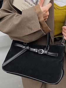Minimalist black suede baguette bag with leather strap and silver metal buckle detail