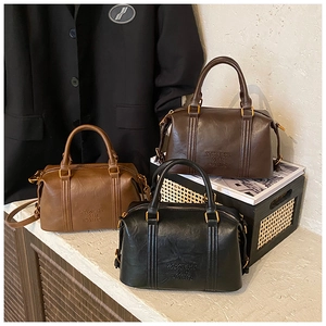 Detailed view of vintage Boston bags in dark brown, light tan and black colors