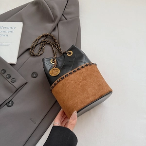 Detail of leopard print bucket bag with rose pendant and bronze chain strap