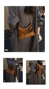 Detailed close-up of brown suede hobo bag with gold logo plaque and bead tassel decoration
