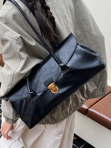 Vintage black faux leather tote bag with gold metal buckle and double shoulder straps