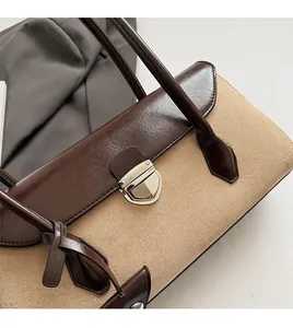 Macro detail of the brown leather and beige suede contrast with silver buckle