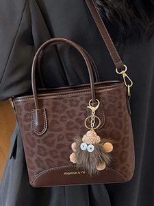 Retro leopard print tote bag with plush charm and shoulder strap for elegant women