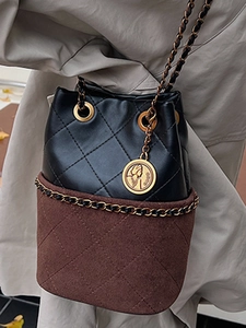 Chic quilted patchwork bucket bag with gold chain strap and medallion charm