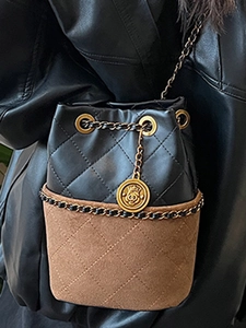 Quilted black leather and brown suede bucket bag with gold chain and round charm