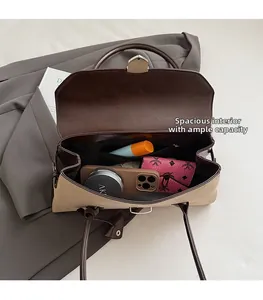 Detail view of the spacious interior capacity showing phone and wallet inside the bag