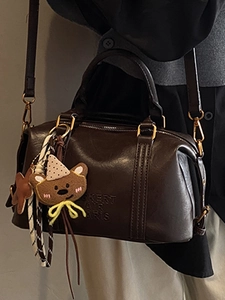 Chic dark brown Boston handbag for women with cute bear charm and crossbody strap