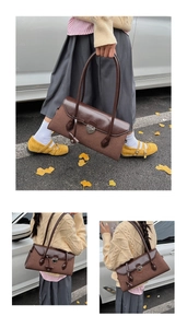 Detail view of a vintage dark brown Boston bag with smooth leather and suede patchwork