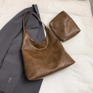 Detail view of brown vintage leather tote bag set with matching small zipper pouch