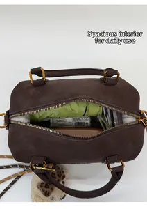 Detail view of the spacious interior of a dark brown vintage Boston bag with umbrella