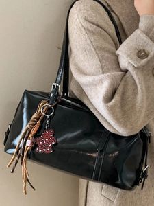 Retro black glossy leather shoulder bag with decorative charms and twin straps for women