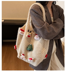 Detail of Christmas knit tote bag with 3D Santa and reindeer plush charms on the handle