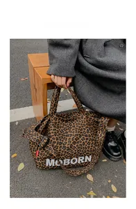 Close-up of leopard print canvas tote bag with adjustable shoulder strap and MOBORN logo