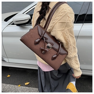 Retro brown Boston bag detail showing the suede texture and flap closure in outdoor setting
