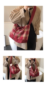 Detail showing red and beige plaid canvas tote with a cute plush bear charm on the strap