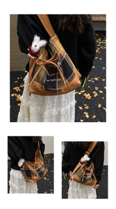 Detail of autumn patchwork tote bag with plaid pattern and cute white plush bunny charm