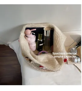 Spacious interior of beige knit tote bag holding skincare bottles and an umbrella