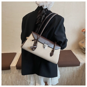 Detail of vintage contrast stitching Boston bag with silver metal buckle on leather