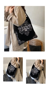 Detailed embroidery view of ethnic style black suede tote bag with white floral pattern