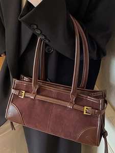 Retro brown suede large baguette bag with golden buckle on professional model