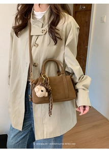 Brown retro crossbody bag with plush bear charm and vintage ribbon detail