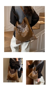 Detailed white ethnic floral embroidery on a vintage brown suede tote bag for women