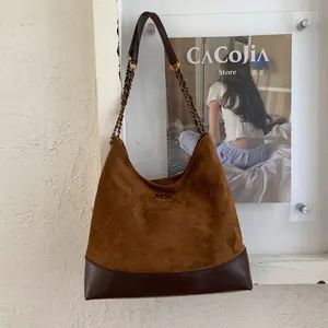 Detail der vintage gesteppten braunen Wildleder-Schultertasche mit Kettenriemen