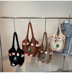 Close-up of knit Christmas tote bag showing fuzzy Santa and reindeer plush patches