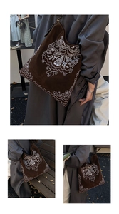 Detailed view of bohemian floral embroidery on brown suede large shoulder tote bag