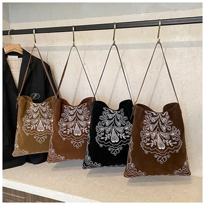Ethnic style suede tote bags featuring floral embroidery displayed in four various colors