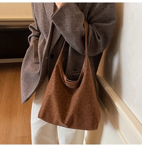 Brown leopard print oversized tote bag styled on shoulder with a minimalist outfit
