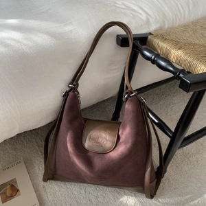 Close-up of retro brown suede tote bag featuring detailed cartoon dog embossed pattern