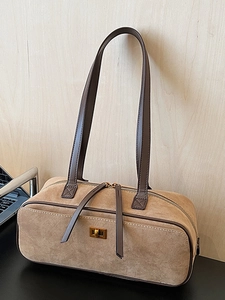 Minimalist camel suede baguette bag with gold twist lock and brown leather shoulder strap