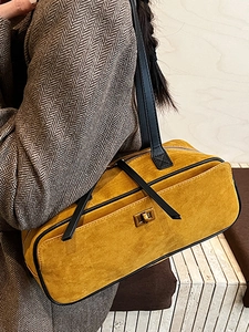 Elegant yellow suede baguette bag with gold twist lock and black leather trim for women
