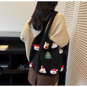 Close-up of black fuzzy shoulder bag with 3D Christmas themed Santa and reindeer patches